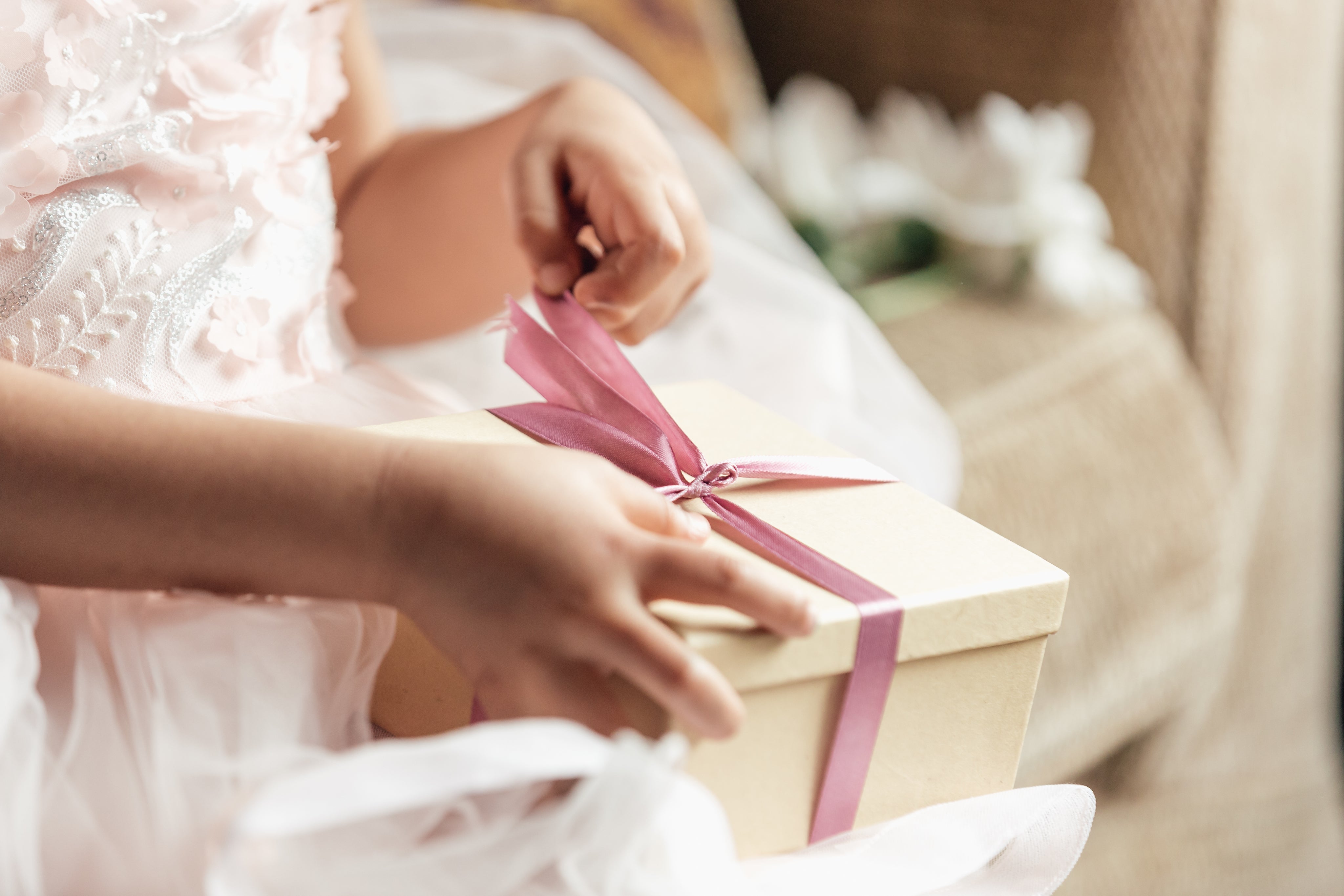 young-girl-opening-gift_56da5117-ecea-4b60-bde9-ef6a13dcaaed.jpg